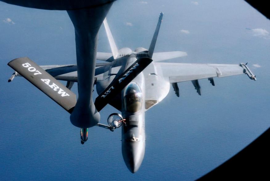 An FA-18 air fighter from the U.S. carrier George Washington is being refuelled by an air tanker over the Pacific near Okinawa Island, southern Japan, December 9, 2010. REUTERS/Kyodo (JAPAN - Tags: MILITARY TRANSPORT) JAPAN OUT. NO COMMERCIAL OR EDITORIAL