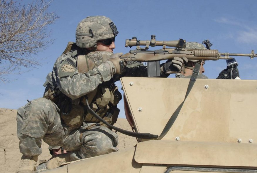 U.S. Army Sgt. Colin Cleek, from Reconnaissance Platoon, 2nd Battalion, 508th Parachute Infantry Regiment, looks through the scope of his rifle onto a mortar range near Ghazni, Afghanistan, on April 1, 2007.   DoD photo by Staff Sgt. Michael L. Casteel, U