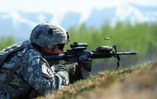 Cpl. Johnny Hurst, assigned to A Company 3rd Battalion (Airborne), 509th Infantry Regiment, a native of Chicago, fires his M4 carbine during a live-fire and movement-to-contact operation on the Infantry Squad Battle Course at Joint Base Elmendorf-Richards