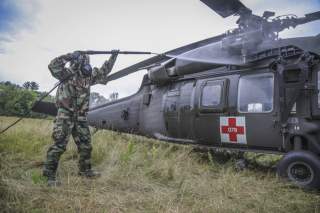 An Army Reserve Soldier assigned to the 308th Chemical Company, 450th Chemical Battalion, 209th Regional Support Group, 76th Operational Response Command sprays water on a 