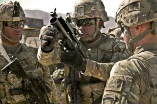 U.S. Army Pfc. Rohan Wright, center, a cavalry scout with a personal security detachment with the 4th Brigade Combat Team, 101st Airborne Division, prepares to fire an M320 Grenade Launcher Module (GLM) at the weapons range at Forward Operating Base Thund