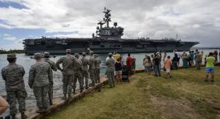 PEARL HARBOR (June 26, 2014) Service members and civilians watch as the aircraft carrier USS Ronald Reagan (CVN 76) transits to Joint Base Pearl Harbor-Hickam to participate in the Rim of the Pacific (RIMPAC) 2014 exercise.
