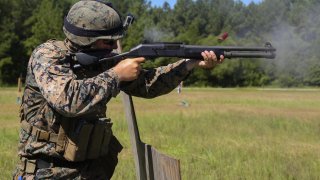 Sgt. James Jackson, Stone Bay alpha range line staff, fires a Benelli M4 shotgun at a target during a Combat Marksmanship Trainer Course at Camp Lejeune. Sep. 15, 2018. (U.S. Marine Corps photo by Cpl. Mark Watola /Released)