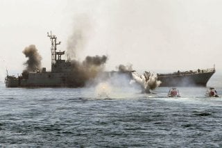 An Iranian warship and speed boats take part in a naval war game in the Persian Gulf and the Strait of Hormuz, southern Iran April 22, 2010. Iran's Revolutionary Guards successfully deployed a new speed boat capable of destroying enemy ships as war games.