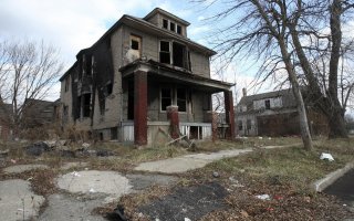 A partially burned, abandoned house is seen in Detroit, Michigan, January 7, 2012. REUTERS/Rebecca Cook.