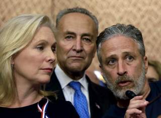 Comedian/director Jon Stewart (R) answers a question at an event to urge U.S. lawmakers to re-authorize the Zadroga Bill at the U.S. Capitol in Washington September 16, 2015. Senators Kirsten Gillibrand (D-NY) (L) and Charles Schumer (D-NY) (C) listen in.