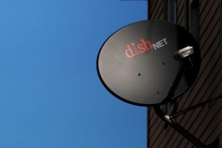 A Dish Network receiver hangs on a house in Somerville, Massachusetts, U.S., February 21, 2017. REUTERS/Brian Snyder