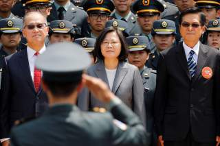 A soldier salutes (L-R) Director of the Institute for National Security Studies Feng Shih-kuan, Taiwanese President Tsai Ing-wen, and Minister of National Defense Yen Teh-fa afterthe joint military academies graduation ceremony, in Taipei, Taiwan June 29,