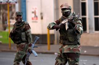 Soldiers open fire to disperse crowds of the opposition Movement for Democratic Change supporters outside the party's headquarters in Harare, Zimbabwe, August 1, 2018. REUTERS/Mike Hutchings