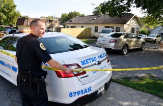 Police place crime scene tape Monday, Aug. 20,, 2018, around a home on Dr. DB Todd Jr. Blvd. in Nashville, Tenn., where Demontrey Logsdon was taken into custody for questioning in last week's shooting outside The Cobra bar