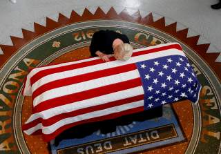 Cindy McCain, wife of U.S. Senator John McCain, touches the casket during a memorial service at the Arizona Capitol in Phoenix, Arizona, U.S., August 29, 2018. Ross D. Franklin/Pool via REUTERS
