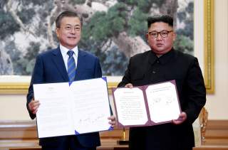 South Korean President Moon Jae-in and North Korean leader Kim Jong Un pose for photographs with the joint statement in Pyongyang, North Korea, September 19, 2018. Pyeongyang Press Corps/Pool via REUTERS
