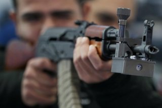 A visitor holds an AK-47 at the Egytian stand during the last day of Egypt Defense Expo, showcasing military systems and hardware, in Cairo, Egypt, December 5, 2018. REUTERS/Mohamed Abd El Ghany