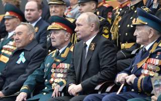 Spectators, including Russia's President Vladimir Putin and Kazakhstan's Former President Nursultan Nazarbayev, attend the Victory Day parade, which marks the anniversary of the victory over Nazi Germany in World War Two, in Red Square in central Moscow, 