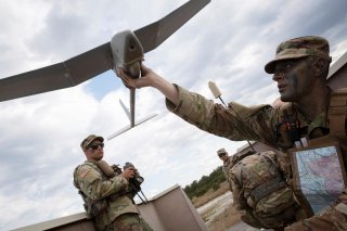 New York Army National Guard Corporal Matthew G. Mena performs a systems check on an RQ-11 Raven B, a small unmanned aerial system or drone, during the field training at Joint Base McGuire-Dix-Lakehurst, New Jersey, U.S. May 15, 2019. New Jersey National 