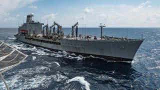 Military Sealift Command fleet replenishment oiler USNS Walter S. Diehl (T-AO 193) pulls alongside hospital ship USNS Mercy (T-AH 19) to deliver supplies and mail by a connected replenishment in the South China Sea August 15, 2016. Picture taken August 15