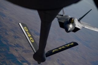 A U.S. Air Force F-22 Raptor, prepares to connect with a KC-135 Stratotanker during an aerial refueling mission above an undisclosed location, out of Al Udeid Air Base, Qatar, in this undated handout picture released by U.S. Air Force on July 29, 2019. Ch