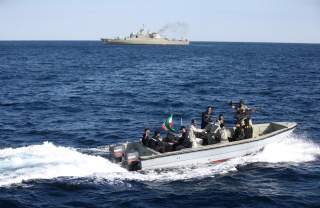 Iranian marine soldiers wave to the camera from a motor boat in the Sea of Oman during the third day of joint Iran, Russia and China naval war games in Chabahar port, at the Sea of Oman, Iran, December 29, 2019. Mohsen Ataei/Fars news agency/WANA (West As