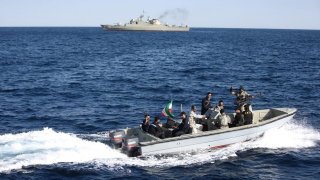 Iranian marine soldiers wave to the camera from a motor boat in the Sea of Oman during the third day of joint Iran, Russia and China naval war games in Chabahar port, at the Sea of Oman, Iran, December 29, 2019. Mohsen Ataei/Fars news agency/WANA (West As