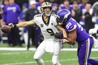 New Orleans Saints quarterback Drew Brees (9) fumbles the ball as he is hit by Minnesota Vikings defensive end Danielle Hunter (99) during the fourth quarter of a NFC Wild Card playoff football game at the Mercedes-Benz Superdome, New Orleans, Louisiana, 