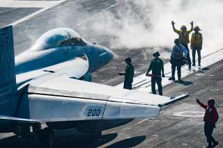 Sailors carry out pre-flight checks on an F/A-18F Super Hornet on the flight deck of the U.S. Navy aircraft carrier USS Harry S. Truman in the Arabian Sea January 6, 2020.