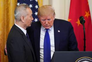 Chinese Vice Premier Liu He talks with U.S. President Donald Trump during a signing ceremony for 