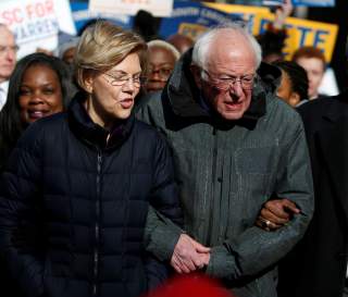 Seven of the Democratic US Presidential candidates including U.S. Senator Elizabeth Warren and Sen. Bernie Sanders, walk arm-in-arm with local African-American leaders during the Martin Luther King Jr. (MLK) Day Parade in Columbia, South Carolina