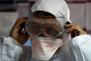 A member of the medical staff puts on protective gear at a new section specialised in receiving any person who may have been infected with coronavirus, at the Al-Bashir Governmental Hospital in Amman, Jordan January 28, 2020.REUTERS/Muhammad Hamed