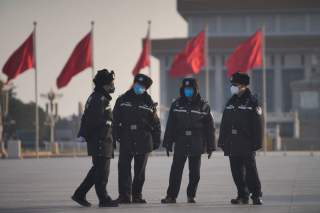 Police officers wearing masks are seen at at the Tiananmen Square, as the country is hit by an epidemic of the new coronavirus, in Beijing, China January 30, 2020. REUTERS/Stringer 