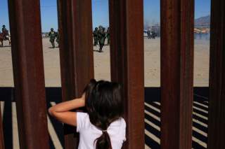 A child looks at U.S. Border Patrol agents conducting a training exercise at the border fence between Ciudad Juarez, Mexico and Sunland Park, U.S., as seen from Ciudad Juarez, Mexico January 31, 2020. REUTERS/Jose Luis Gonzalez