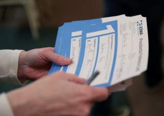 An Iowa Caucus precinct worker counts Iowa Democratic Caucus paper ballots as caucus votes are tallied after a Democratic presidential caucus at West Des Moines Christian Church in West Des Moines, Iowa, U.S., February 3, 2020.