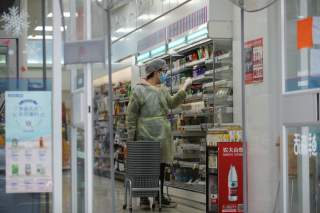 A worker is seen inside a convenience store following an outbreak of the novel coronavirus in Wuhan, Hubei province, China February 11, 2020. REUTERS/Stringer