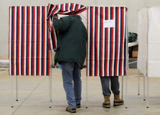 A voter enters a voting booth to fill out a ballot to vote in New Hampshire's first-in-the-nation U.S. presidential primary election at the Stark volunteer fire dept. in Stark, New Hampshire, U.S., February 11, 2020. REUTERS/Brendan McDermid