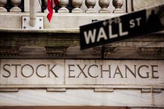 A street sign for Wall Street hangs in front of the New York Stock Exchange May 8, 2013. REUTERS/Lucas Jackson