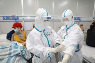  A medical worker writes down a patient's dietary information on a colleague's protective suit inside Leishenshan hospital, a makeshift hospital to treat patients with the novel coronavirus, in Wuhan, Hubei province, China February 16, 2020. Picture taken