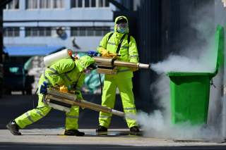 Volunteers in protective suits disinfect a factory with sanitizing equipment, as the country is hit by an outbreak of the novel coronavirus, in Huzhou, Zhejiang province, China February 18, 2020. China Daily via REUTERS