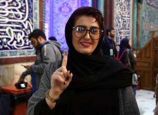 A woman shows her ink-stained finger after she casted her vote during parliamentary elections at a polling station in Tehran, Iran February 21, 2020. Nazanin Tabatabaee/WANA (West Asia News Agency) via REUTERS 