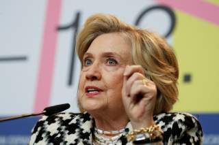 Hillary Clinton gestures as she attends a news conference to promote the movie 