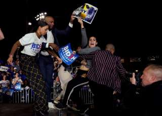 Anti-dairy industry protestors are pulled from the stage as Democratic U.S. presidential candidate and former Vice President Joe Biden speaks at his Super Tuesday night rally in Los Angeles, California, U.S., March 3, 2020. REUTERS/Kyle Grillot