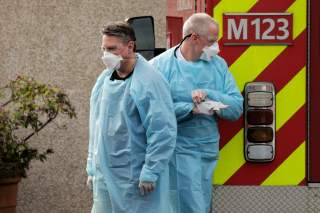 Medics prepare to transfer a patient into an ambulance at the Life Care Center of Kirkland, the long-term care facility linked to several confirmed coronavirus cases in the state, in Kirkland, Washington, U.S. March 5, 2020. REUTERS/David Ryder