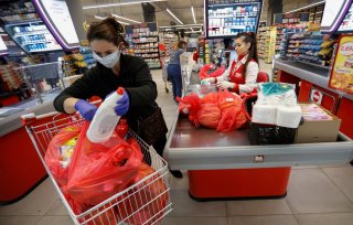 A women wearing a mask packs her groceries after the government limited the number of customers in supermarkets to 50 at a time due to coronavirus (COVID-19) threat in Podgorica, Montenegro March 16, 2020. REUTERS/Stevo Vasiljevic