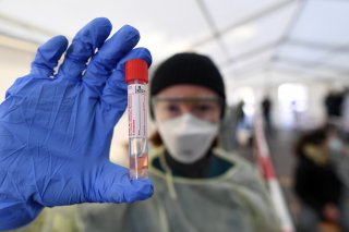 A medical employee presents a smear taken at a special corona test center for public service employees such as police officers, nurses and firefighters during a media presentation as the spread of the coronavirus disease (COVID-19) continues, in Munich, G