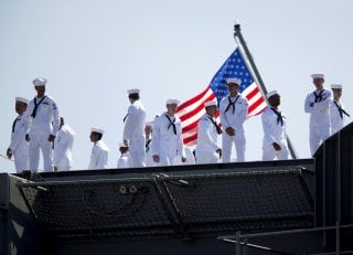 Sailors man the rails as the USS Ronald Reagan, a Nimitz-class nuclear-powered super carrier, departs for Yokosuka, Japan from Naval Station North Island in San Diego, California August 31, 2015. REUTERS/Mike Blake