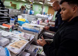 Hospitalman Jeremiah Lewis, from San Antonio, organizes medical supplies aboard the Military Sealift Command hospital ship USNS Mercy off the coast of southern California March 24, 2020. Picture taken March 24, 2020. U.S. Navy/Mass Communication Specialis