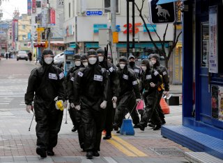 South Korean soldiers in protective gear make their way while they disinfect buildings downtown, following the rise in confirmed cases of coronavirus disease (COVID-19) in Daegu, South Korea, March 15, 2020. REUTERS/Kim Kyung-Hoon