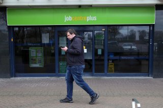A man walks past a job centre as the spread of the coronavirus disease (COVID-19) continues, Stevenage, Britain, March 31, 2020. REUTERS/Peter Cziborra