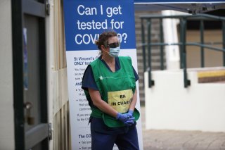 A healthcare professional waits at a pop-up clinic testing for the coronavirus disease (COVID-19) at Bondi Beach, after several outbreaks were recorded in the area, in Sydney, Australia April 1, 2020. REUTERS/Loren Elliott
