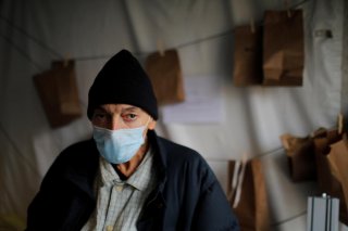 Kevin Keeley, who has been homeless for eight months and may have come in contact with someone with coronavirus disease (COVID-19), poses for a portrait outside a quarantine tent run by Boston Health Care for the Homeless in Boston, Massachusetts, U.S., A