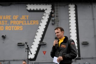 Captain Brett Crozier, commanding officer of the U.S. Navy aircraft carrier USS Theodore Roosevelt, addresses the crew during an all-hands call on the ship’s flight deck in the eastern Pacific Ocean December 19, 2019. Picture taken December 19, 2019. U.S.