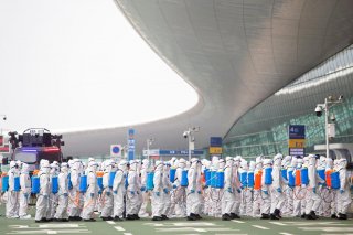 Firefighters in protective suits are seen during an operation to disinfect Wuhan Tianhe International Airport before the airport resumes its domestic flights on April 8, in Wuhan, Hubei province, the epicentre of China's novel coronavirus disease (COVID-1